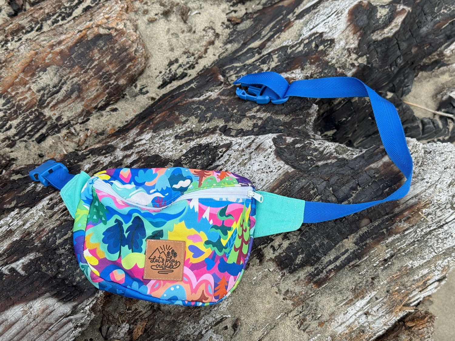 child-size fanny pack on driftwood